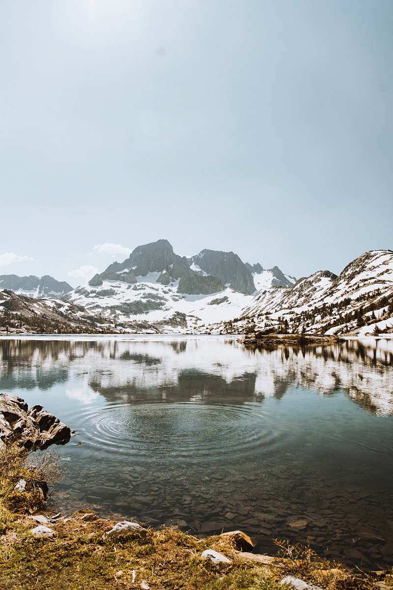 iphone backgrounds body of water surrounded by mountains covered with snow during daytime garnet lake